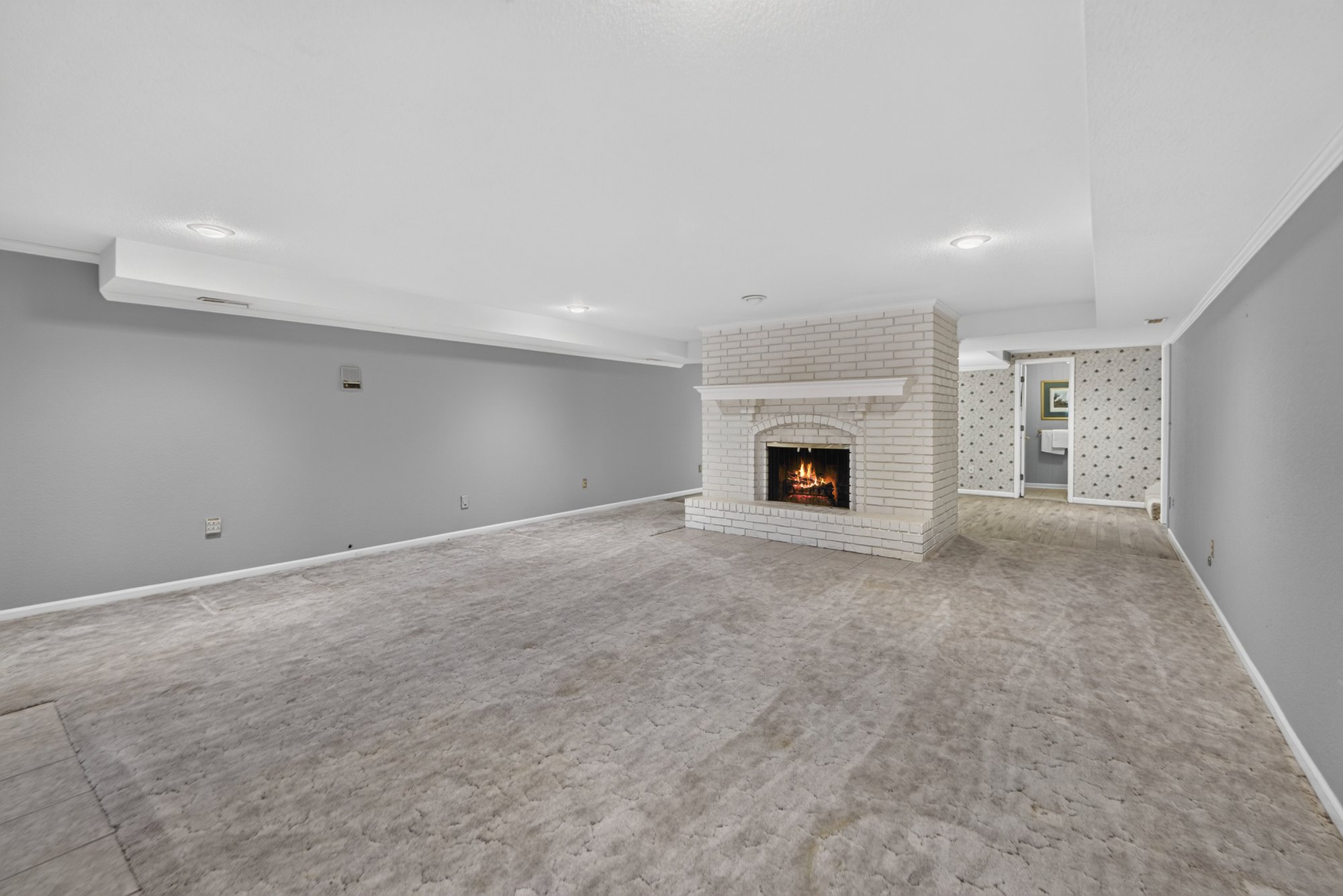 Lower-level rec room with fireplace